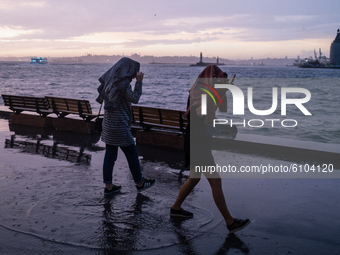 People run from heavy rainfall in Istanbul, Turkey on October 19, 2020. (