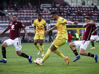 Cagliari defender Charalampos Lykogiannis (22) fights for the ball against Torino defender Mergim Vojvoda (27) and Torino defender Lyanco (4...