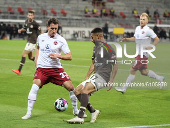 Georg Margreiter of 1. FC Nuernberg and Daniel-Kofi Kyereh of FC St. Pauli battle for the ball during the Second Bundesliga match between FC...