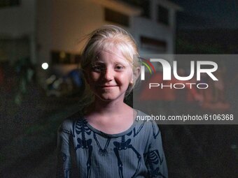 A young blond Syrian refugee girl. Portraits of young children refugees, minors boys and girls, asylum seekers from various countries such a...