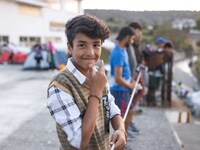 A young refugee boy is smiling. Portraits of young children refugees, minors boys and girls, asylum seekers from various countries such as S...