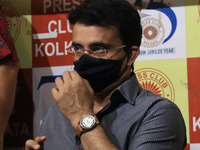 Board of Control for Cricket in India (BCCI) President Sourav Ganguly adjusts his protective face mask during a book release event at Kolkat...