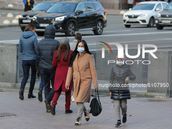 A woman with a child with the face masks on walk in downtown Kyiv, Ukraine, October 20, 2020. 173,788 active cases of Covid-19 confirmed acr...