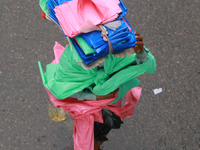 A man sells polythene during the rainfall in Dhaka, Bangladesh on October 21, 2020. (