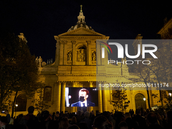 People gathered on the Place de la Sorbonne in Paris on October 21, 2020, to watch a live broadcast on a giant screen of the national tribut...