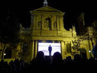People gathered on the Place de la Sorbonne in Paris on October 21, 2020, to watch a live broadcast on a giant screen of the national tribut...