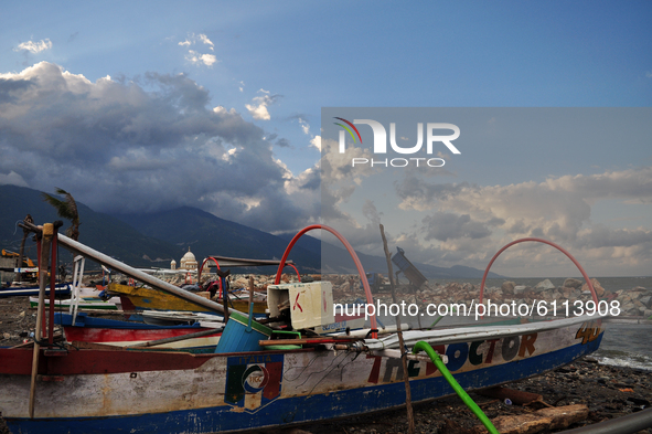 A truck is moving a load of rock to the beach, as raw material for the construction of a wave embankment in Besusu Village, Palu City, Centr...