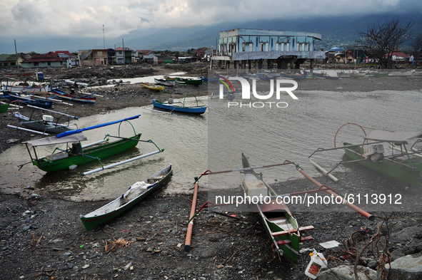 A fishermen's boat is parked off the beach where the tsunami waves hit Besusu Village, Palu City, Central Sulawesi, because it cannot carry...
