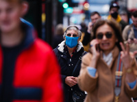 An elderly woman wears a face mask amid shoppers on Oxford Street in London, England, on October 22, 2020. Retail sales figures from the UK...