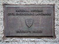 An inscription of the Brooklyn Bridge in New York City in the United States as seen during a cloudy day with tourists and locals on it. The...