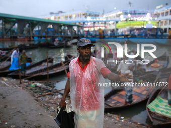 Boatmen wait for passenger along the Buriganga River on a rainy day in Dhaka, Bangladesh on October 23, 2020.  Rainfall occurs in various pa...