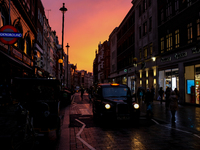 The sun sets on the Long Acre, in Covent Garden, London on October 23, 2020. (