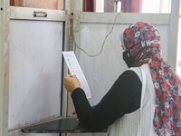  A woman vote inside a polling station at Dokki district during the first round of the first phase of the Egyptian parliamentary election, O...