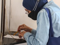 A woman vote inside a polling station at Dokki district during the first round of the first phase of the Egyptian parliamentary election, O...