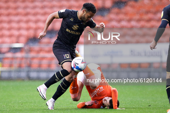 Milton Keynes Dons' Louis Thompson competes for possession with Blackpool's Ben Woodburn during the Sky Bet League 1 match between Blackpool...