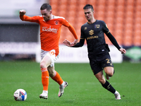 Blackpool's Oliver Turton (left) in action with Milton Keynes Dons' Daniel Harvie during the Sky Bet League 1 match between Blackpool and MK...