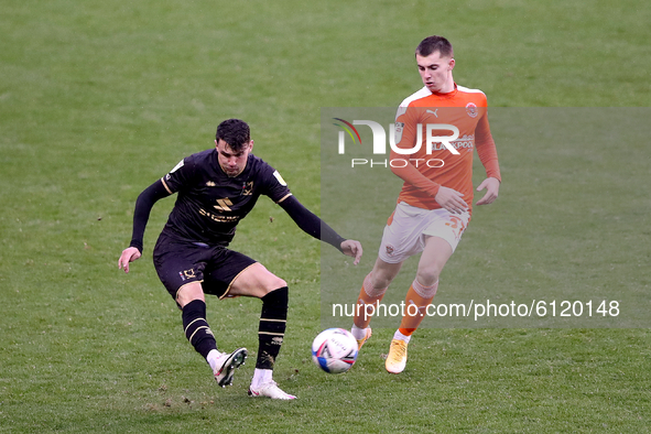 Blackpool's Ben Woodburn (right) in action with Milton Keynes Dons' Regan Poole during the Sky Bet League 1 match between Blackpool and MK D...