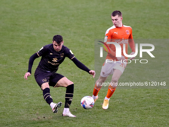Blackpool's Ben Woodburn (right) in action with Milton Keynes Dons' Regan Poole during the Sky Bet League 1 match between Blackpool and MK D...