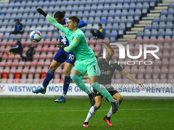Plymouth keeper Michael Cooper gets to the ball before Wigans Will Keane      during the Sky Bet League 1 match between Wigan Athletic and P...
