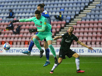Plymouth keeper Michael Cooper gets to the ball before Wigans Will Keane      during the Sky Bet League 1 match between Wigan Athletic and P...