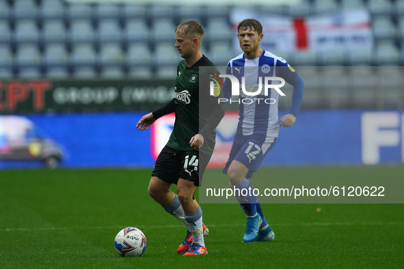 Plymouths Ben Reeves holds off Wigans Mathew Palmer during the Sky Bet League 1 match between Wigan Athletic and Plymouth Argyle at the DW S...