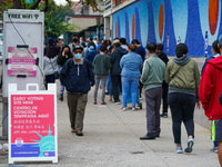 People wait in a line to vote at The Boys' Club of New York - Abbe Clubhouse in Flushing, Queens during early voting for the U.S. Presidenti...