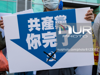 A protester holding a sign calling for the end of the Chinese Communist Party on October 25, 2020 in Taipei, Taiwan. On Saturday Taiwan, Tib...