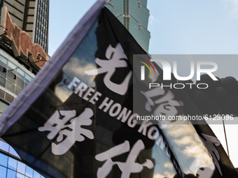 A protester holding a sign calling Hong Kong Revolution with the Taipei 101 Tower in the background on October 25, 2020 in Taipei, Taiwan. O...