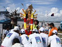 Municipal workers immerse an idol of the Hindu goddess Durga in the waters of the river Brahmaputra on the last day of the Durga Puja festiv...