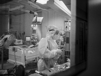 (EDITOR'S NOTE: IMAGE HAS BEEN CONVERTED TO BLACK AND WHITE) A medical worker in personal protective equipment (PPE)is seen in the COVID lev...