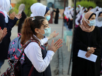 Palestinian students participate in a morning activity as schools partially reopened amid the coronavirus disease (COVID-19) outbreak,  in G...