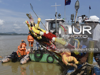 Municipal workers carry an idol of Hindu Goddess Durga for immersion in the waters of Brahmaputra river during the last day of Durga Puja fe...