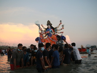 Hindu devotees immerse an idol of Goddess Durga into the Bay of Bengal on the last day of the Durga Puja festival in Chittagong, Bangladesh...
