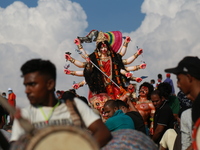 Hindu devotees carry an idol of Goddess Durga to immmerse into the Bay of Bengal on the last day of the Durga Puja festival in Chittagong, B...