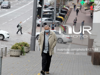 A man wearing a protective face mask amid the COVID-19 coronavirus epidemic walks in the center of Kyiv, Ukraine on 26 October 2020.  348 92...