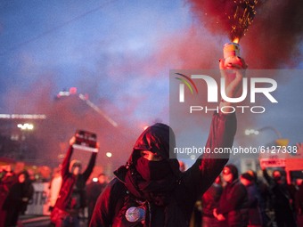 Woman holds a flare during Blockade of Warsaw organied by feminist Womans Strike against new abortion law in Warsaw on October 26, 2020. (