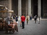    A staffer waits for clients in central Rome as Italy is facing a surge in the coronavirus disease (COVID-19) infections in Rome, Italy, O...