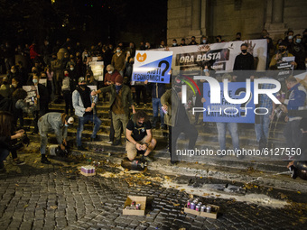   Bartenders pour beer on the ground during a protest against latest Coronavirus restrictions in Trilussa square as Italy is facing a surge...