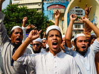 Muslim protesters display placards during the protest against French president Emmanuel Macron in Dhaka, Bangladesh on 28 october 2020. (