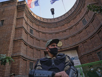 A member of the Iranian special police force monitors an area during a protest gathering in front of the French embassy in Tehran on October...