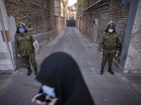 Two members of the Iranian special police force monitors an area near the French embassy during a protest gathering in Tehran on October 28,...