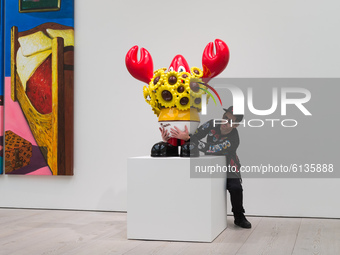  Pop artist Philip Colbert poses with his 'Lobster Sunflower' during the world’s first robot-only private view for his Lobsteropolis exhibit...