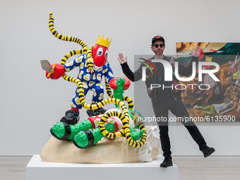  Pop artist Philip Colbert poses next to 'Snake-Hunt' sculpture during the world’s first robot-only private view for his Lobsteropolis exhib...