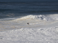 Surfer catches a giant wave at Praia do Norte, in Nazaré, on October 29, 2020 (