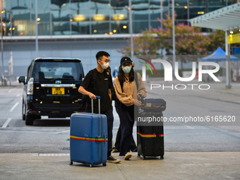 Travelers head to the airport entrance in Hong Kong international airport on November 3, 2020 in Hong Kong, China. (
