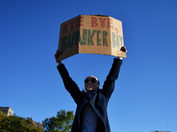 A man in a Joe Biden mask celebrates in Washington Square Park as New Yorkers take to the streets following the announcement of President Do...
