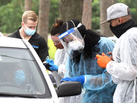 Health workers provide free COVID-19 rapid tests at a drive through site at Barnett Park on November 9, 2020 in Orlando, Florida. Cases of C...