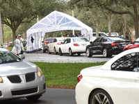People in cars line up to receive free COVID-19 rapid tests at a drive through site at Barnett Park on November 9, 2020 in Orlando, Florida....