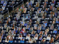 Cutout photos of veterans are placed in the spectator seating area near the endzone during the first half of an NFL football game between th...