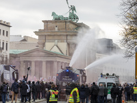 People take part in a demonstration against the Coronavirus regulations in Berlin, Germany, on November 18, 2020. The riot police used tearg...
